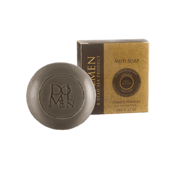 Round bar of Dolmen mud soap with Shea butter in front of its packaging.