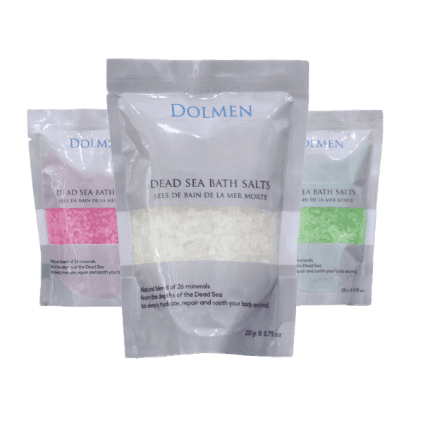 Three bags of Dolmen Dead Sea Bath Salts in pink, white, and green colors